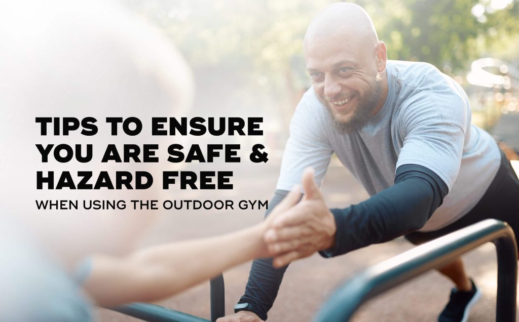 Two people using an outdoor gym equipment to do push up.
