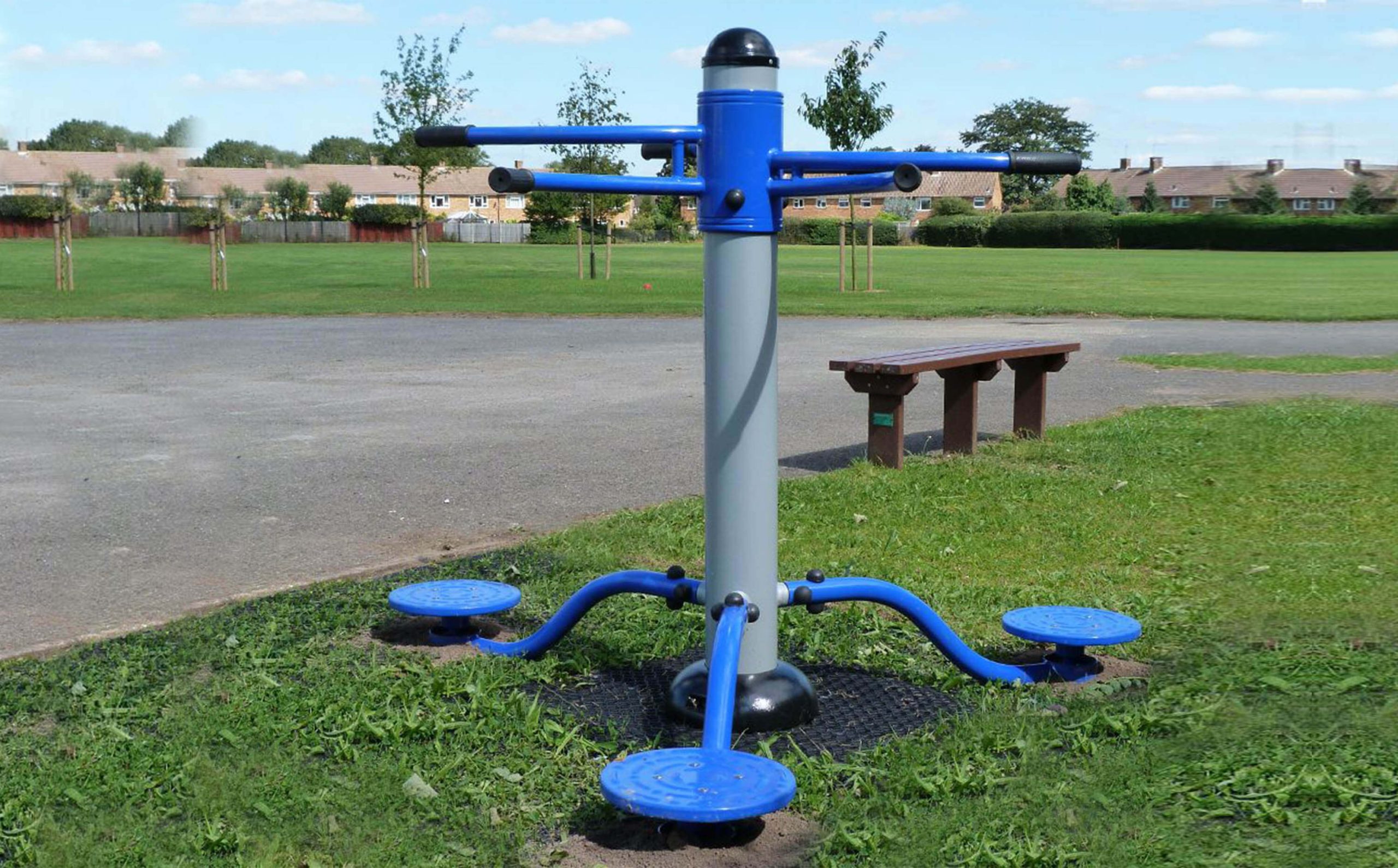 A blue torso twist in the middle of a park.