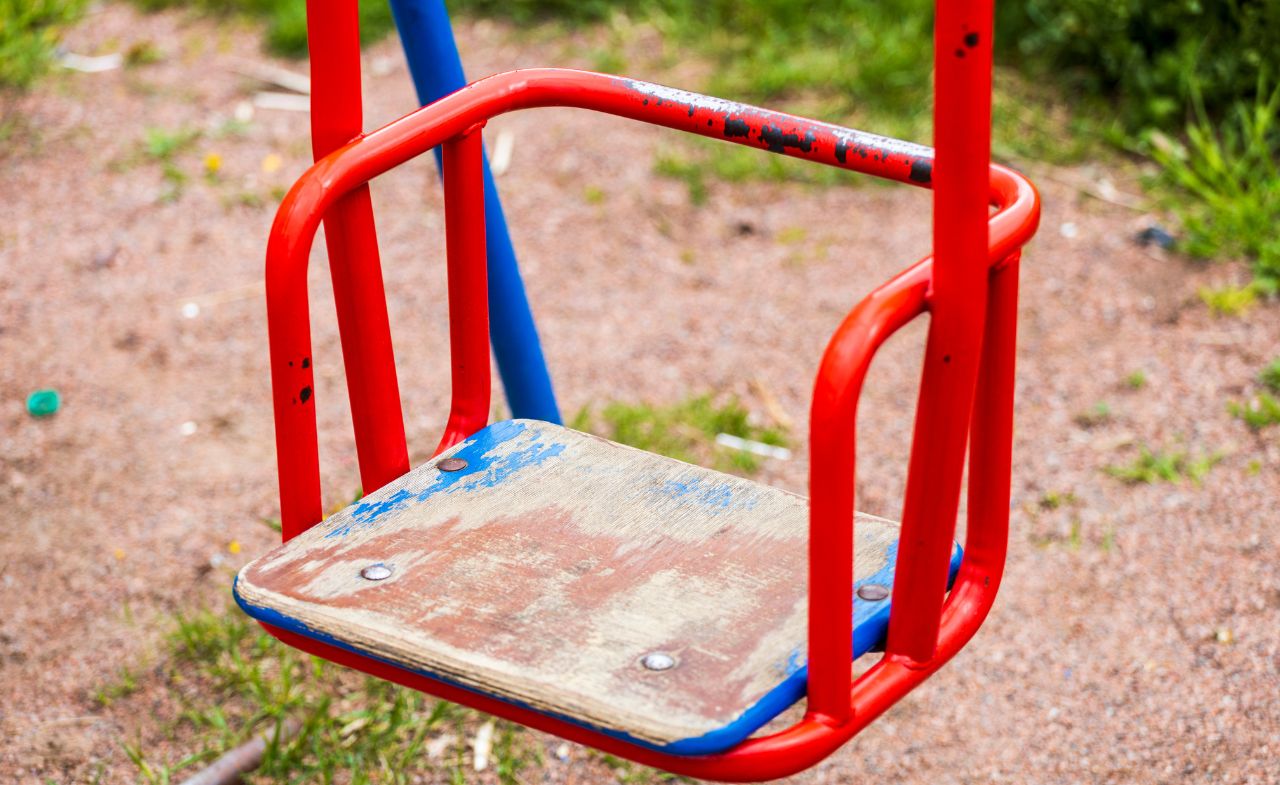 A piece of damaged playground equipment in the local park.