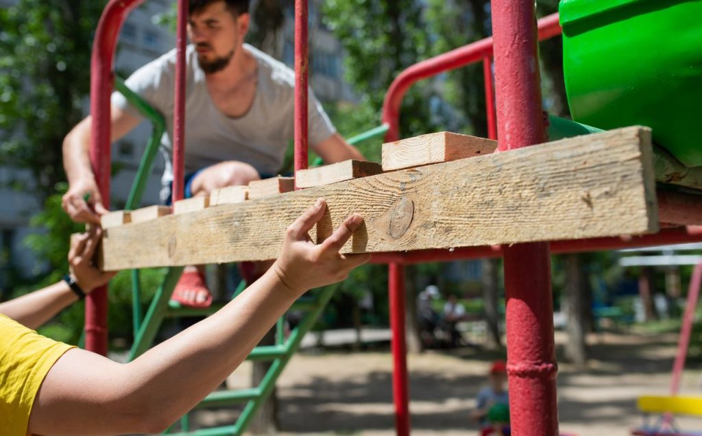 A team of workers, performing playground construction.