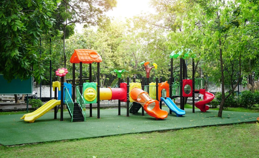 A colorful full set playground in the community park shows good condition.